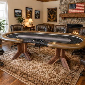 May include: An oval poker table with a dark gray felt surface, a padded brown leather-like rail, and built-in gold-toned cup holders. The table features two wooden pedestal bases and is surrounded by six matching brown leather office chairs.