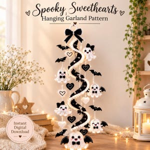 May include: A hanging garland pattern titled Spooky, Sweethearts featuring a central black and white spiral structure decorated with crocheted white ghosts wearing black bow ties, black bats, and white and black hearts with small white pearls.