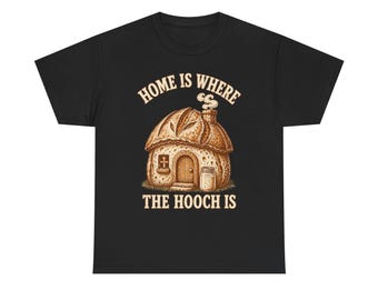 May include: A black t-shirt featuring a graphic of a house shaped like a loaf of bread with a chimney emitting smoke, a small door, and a jar next to it. The text above and below the illustration reads, "HOME IS WHERE THE HOOCH IS" in beige.
