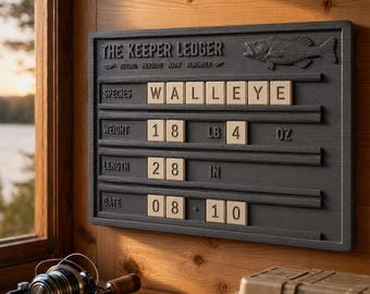 May include: A rectangular dark gray wall-mounted fishing record board titled THE KEEPER LEDGER with a fish relief. It features horizontal slots holding beige tiles displaying WALLEYE, 18 LB 4 OZ, 28 IN, and 08 10, used to track fishing catches.