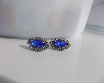 Dainty Blue Sapphire Stud Earrings surrounded by sparkling white cubic zirconia