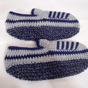 May include: A pair of crocheted slippers in blue and gray with a striped pattern.