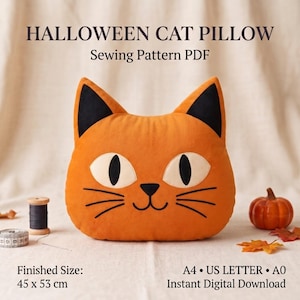 Op de afbeelding: Een oranje kussen in de vorm van een kat met zwarte oren, witte ogen met zwarte pupillen en zwarte snorharen. Tekst: HALLOWEEN CAT PILLOW Sewing Pattern PDF. Afgewerkte maat: 45 x 53 cm. A4, US LETTER, A0, Directe digitale download.