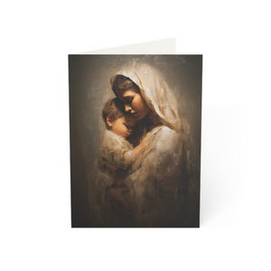 May include: A greeting card featuring an oil painting style illustration of a person with a head covering holding a small child. The figures are rendered in soft, muted tones of beige, cream, and dark brown with a textured, painterly finish.