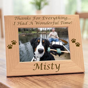 May include: A light-colored wooden picture frame featuring the engraved text "Thanks For Everything... I Had A Wonderful Time!" at the top, the name "Misty" at the bottom, and two brown paw print icons on each side of the central photo.