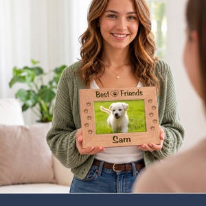 May include: A rectangular light-colored wooden picture frame featuring the engraved text "Best Friends" at the top with a paw print icon, and the name "Sam" at the bottom. The frame is decorated with small engraved paw prints.