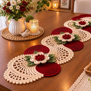 May include: A long, decorative table runner featuring a repeating pattern of cream-colored crocheted lace circles and solid deep red circular motifs. The runner is embellished with three-dimensional crocheted flowers in red and cream with green leaves.