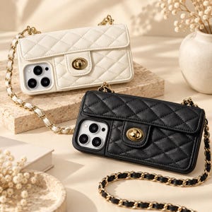 May include: Two phone cases with a quilted texture and a gold-tone turn-lock closure. One case is white and the other is black. Each case features a long shoulder strap made of a gold-tone metal chain interwoven with matching leather-like material.