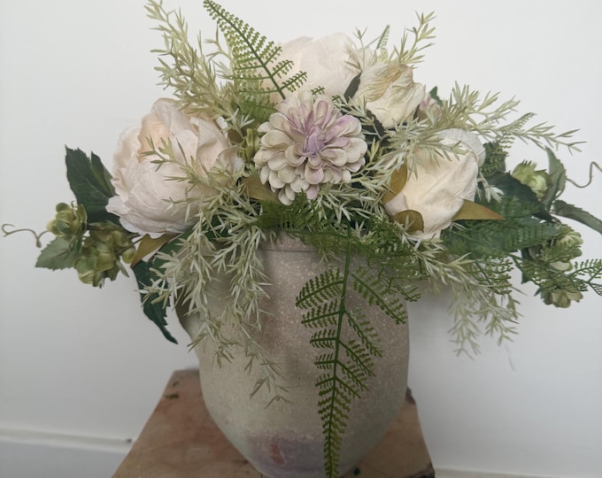 Faux flower table arrangement in vase.