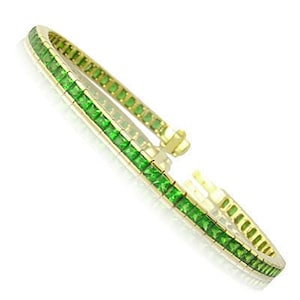 May include: A gold bracelet with a row of emerald green square-shaped gemstones.