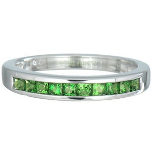 May include: A silver band ring with a row of green square-shaped gemstones.