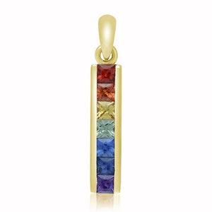May include: A gold pendant featuring a vertical row of seven square-cut gemstones in rainbow colors: red, orange, yellow, green, blue, indigo, and violet. The pendant has a loop at the top for a chain.