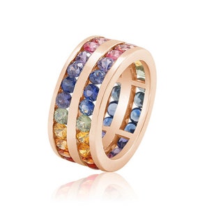 May include: A rose gold band ring with a rainbow of sapphires set in a double row.