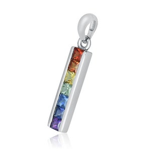 May include: A silver pendant with a rectangular design, featuring a row of square-cut gemstones in rainbow colors: red, orange, yellow, green, blue, indigo, and violet. The pendant has a loop at the top for a chain.