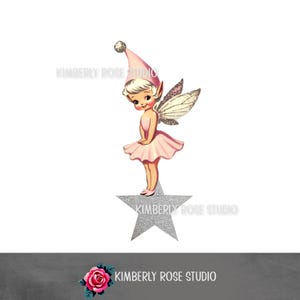 May include: A pink fairy with silver glitter wings stands on a silver glitter star. She is wearing a pink dress and a pink and white hat. The fairy has blonde hair and blue eyes.