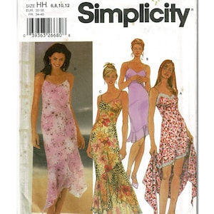 May include: Simplicity sewing pattern 5559 for size HH 6, 8, 10, 12. The envelope features illustrations of four variations of a spaghetti strap dress with a ruffled hem, including a pink floral print, a vibrant tropical print, and a solid lavender.