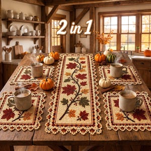 May include: A 2 in 1 table runner and placemat set featuring a beige woven fabric with a decorative border and a pattern of autumn maple leaves in shades of red, orange, and brown. The set includes four square placemats and one rectangular runner.