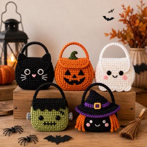 May include: Five small crochet Halloween treat bags featuring a black cat, an orange jack-o'-lantern, a white ghost, a green Frankenstein monster, and a black witch with orange hair and a purple hat, all with handles and embroidered details.