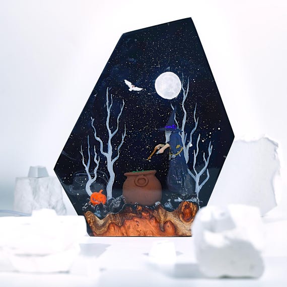 A handmade glowing diorama lamp with a witch silhouette under a full moon in an enchanted forest — spooky, atmospheric, and the kind of thing that makes a room look like a movie set.