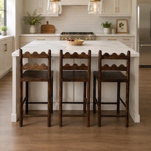 May include: Three dark brown wooden bar stools with scalloped backrests and square seats. Each stool features four straight legs connected by horizontal support bars on all sides, providing a stable base for seating at a kitchen island counter.