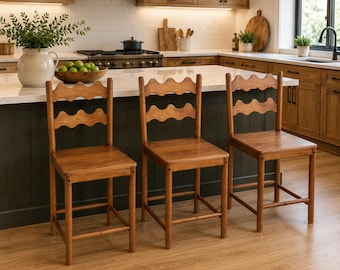 May include: Three wooden counter stools with a medium brown finish, each featuring a square seat, four straight legs with connecting footrests, and a backrest composed of two horizontal slats with a distinct wavy, scalloped edge design.
