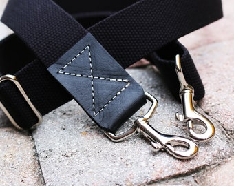 1.50 in wide - Black adjustable cotton webbing shoulder strap with black leather accent - 1.5 in. wide - Cross Body Messenger