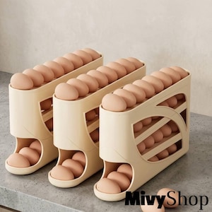 May include: Three beige plastic egg dispensers arranged in a row, each featuring a tiered gravity-fed design that holds multiple brown eggs. The structures have open side panels and a curved front opening at the base for easy access to the eggs.