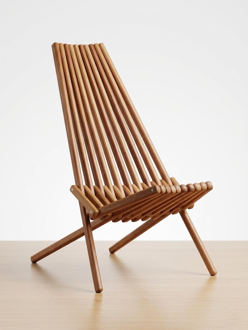 May include: A folding chair constructed from multiple parallel light brown wooden slats. The chair features a tall, angled backrest and a low seat, both formed by the continuous arrangement of these rounded wooden rods connected by metal hardware.