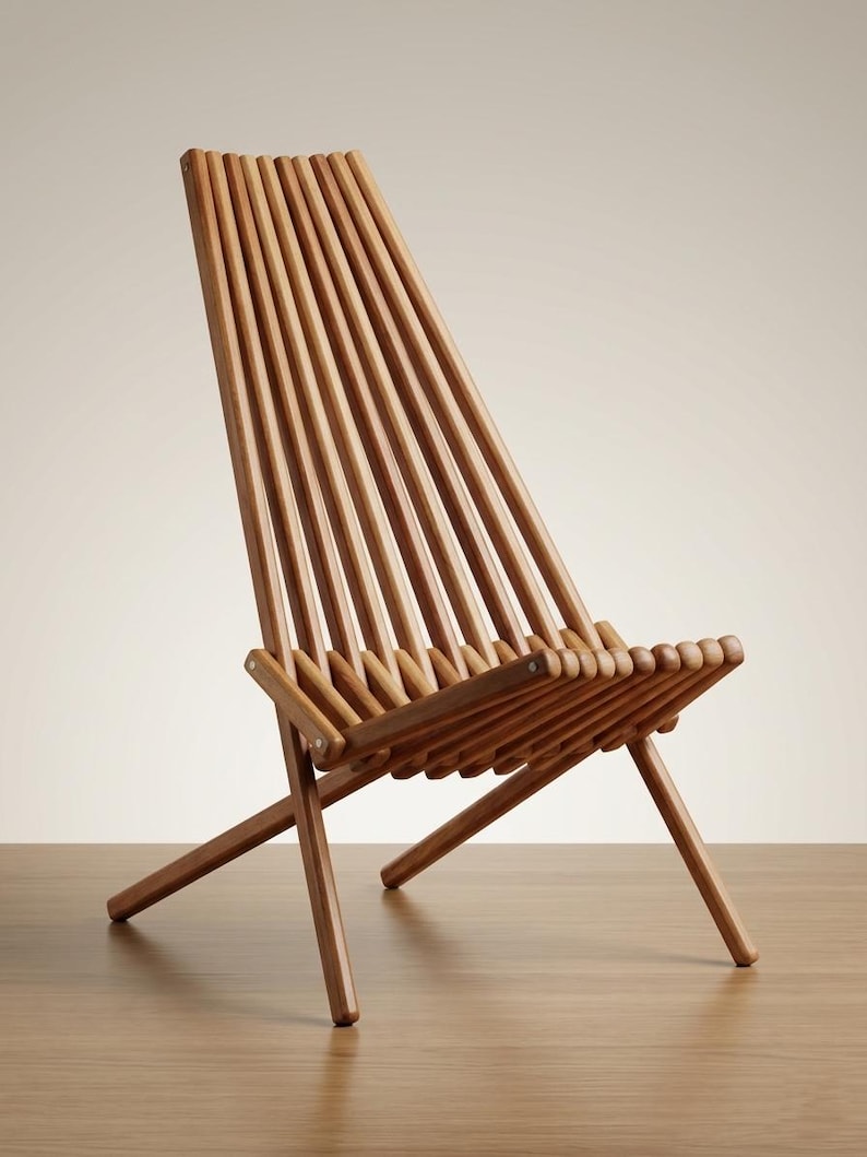 May include: A folding chair constructed from multiple vertical wooden slats in a warm brown tone. The chair features a high, angled backrest and a seat formed by parallel wooden rods, supported by a simple cross-leg frame design.