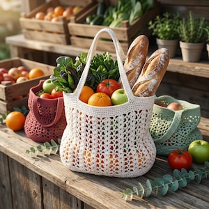 May include: A white crocheted market bag filled with two long crusty baguettes, fresh green leafy vegetables, bright red tomatoes, and round orange citrus fruits. The bag features an openwork stitch pattern and two sturdy handles for carrying.
