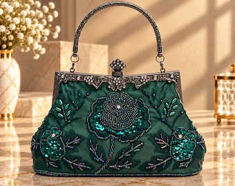 May include: A dark green satin handbag featuring intricate floral embroidery with dark green beads and sequins. The bag has a metallic silver-toned frame with ornate filigree detailing, a single arched handle, and a decorative clasp closure.