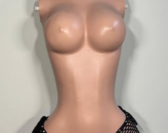 May include: A black fishnet bikini bottom featuring a V-shaped waistband adorned with small, multicolored rhinestones. The garment includes side tie closures and a wide-hole mesh construction, displayed on a neutral-toned mannequin torso.