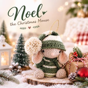 May include: A crocheted mouse ornament named Noel the Christmas Mouse, featuring a green and white striped hat with a large cream pom-pom, a matching green and white striped sweater, and a gold hanging loop, displayed on a wooden slice.