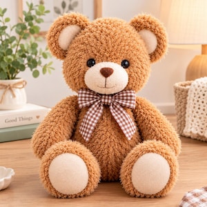 May include: A plush teddy bear with textured brown fur, featuring a cream-coloured muzzle, inner ears, and foot pads. The bear has dark round eyes, a brown stitched nose, and a brown and white checkered ribbon tied around its neck.