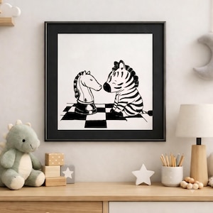 May include: A framed black and white wall art print featuring a cartoon zebra sitting on a checkered board and facing a chess knight piece. The illustration uses bold lines and high contrast to depict the zebra and the chess piece clearly.