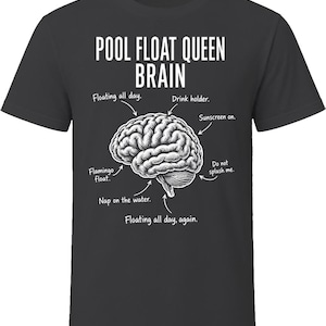 May include: A black t-shirt featuring a white graphic of a human brain with labels pointing to different parts. The text reads: POOL FLOAT QUEEN BRAIN, Floating all day, Drink holder, Sunscreen on, Do not splash me, Flamingo float, Nap on the water, Floating all day, again.