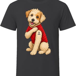 May include: A charcoal gray t-shirt featuring a graphic of a light brown, curly-haired dog wearing a red t-shirt. The dog is sitting and pointing to a tattoo on its upper arm that reads I heart MOM, with a small black heart symbol between the words.