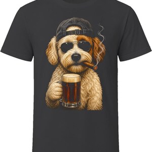 May include: A charcoal gray t-shirt featuring a graphic of a fluffy, light brown dog wearing a black baseball cap and dark sunglasses. The dog is holding a glass mug of dark beer with foam and has a lit cigar in its mouth with a trail of smoke.