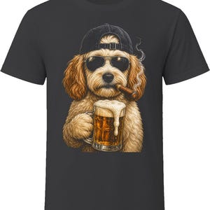 May include: A charcoal gray t-shirt featuring a graphic illustration of a golden-colored dog wearing a black baseball cap and dark sunglasses. The dog is holding a glass mug of beer with foam and has a lit cigar in its mouth with visible smoke.