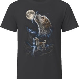 May include: A charcoal gray t-shirt featuring a graphic print of a dog standing on a rock near a waterfall, looking up at a large full moon. A larger, ethereal image of the dog's head is superimposed in the night sky above the forest scene.