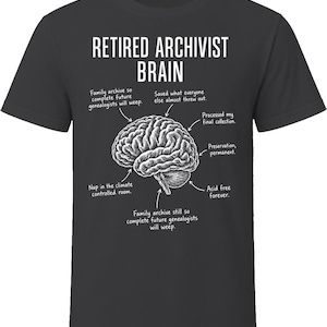 May include: A charcoal gray short-sleeve t-shirt featuring a white graphic of a human brain with labels pointing to different sections. The text reads: RETIRED ARCHIVIST BRAIN, with annotations about family archives, preservation, and acid-free storage.