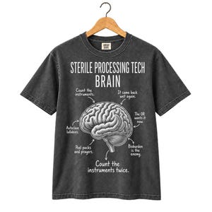 May include: A charcoal gray short-sleeve t-shirt featuring a white graphic of a human brain. The text reads: Sterile Processing Tech Brain, Count the instruments, It came back wet again, The OR wants it now, Bioburden is the enemy, Count the instruments twice, Autoclave lullabies, Peel packs and prayers.