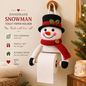 May include: A handmade crochet snowman toilet paper holder featuring a white snowman with a black top hat, a red scarf with a wooden button, and black mittens. The snowman has a carrot-colored nose, black eyes, and pink cheeks, holding a roll of white toilet paper.