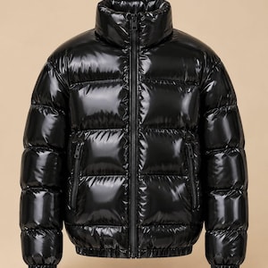 May include: A black puffer jacket with a high collar and a glossy, reflective finish. The jacket features horizontal quilted panels, a full-length central zip, and two side pockets with vertical zips. The cuffs and hem are finished with elasticated trim.