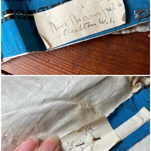 May include: Two handwritten labels sewn onto a blue and white fabric. The first label reads "Mrs. Hampshire, Clinton, W.I." The second label reads "Mrs. Reese, Rustoff".