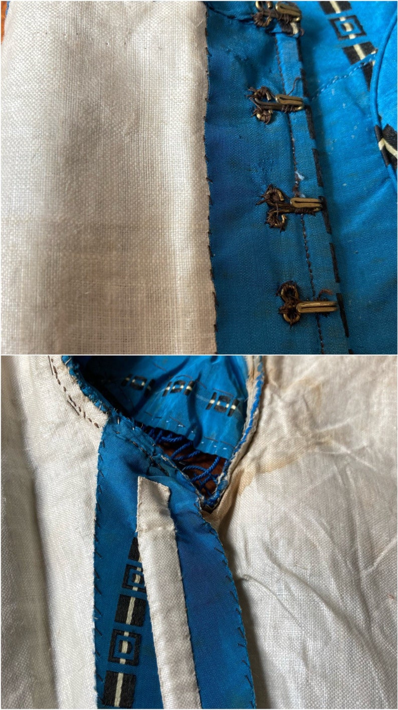May include: Close-up of a blue and white fabric with a black and white geometric pattern. The fabric is sewn together with a white thread. The fabric is folded over and the edges are visible.