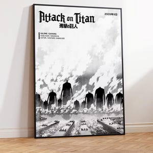 May include: A framed black and white poster featuring the Attack on Titan title, the Japanese text 進撃の巨人, and the date 2009年9日. The artwork depicts a group of large, dark, faceless humanoid figures standing over a coastal town with clouds.