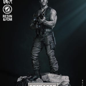 May include: A 1/6 scale monochrome resin and FDM figure of a muscular character wearing a tactical vest and cargo pants, holding a firearm. The figure stands on a rocky base with a plaque labeled PREDATOR. Text includes PRESUPPORTED, TESTED, and WICKED.
