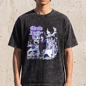 May include: A black acid-wash t-shirt featuring a graphic print of the character Chrollo Lucilfer from Hunter x Hunter. The design includes purple and white stylized flames, the text Chrollo Lucilfer, and the Hunter x Hunter logo in white.