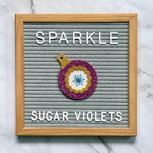May include: A gray letter board with a wooden frame displays the words 